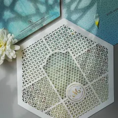 A modern, hexagonal invitation with delicate laser-cut details. We work with designers to create unique shapes and formats that stand out.
