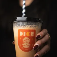 A moody, dark shot of a coffee shake. This style creates a cozy and indulgent feeling, perfect for promoting rich, decadent beverages.