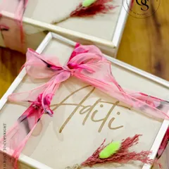 The exterior of my personalized bridesmaid proposal box. The wooden lid is engraved with each bridesmaid's name and adorned with a beautiful printed fabric ribbon and a dried floral accent.