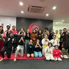 The full group of participants from our "Stronger Minds, Stronger Moves" workshop. These events bring people together to learn about both physical defense and mental resilience in a supportive community setting.