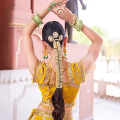 A creative shot showing the back of the hair and the beautiful hand jewellery. The rings and hairpins are perfectly coordinated with the rest of the set for a cohesive look.