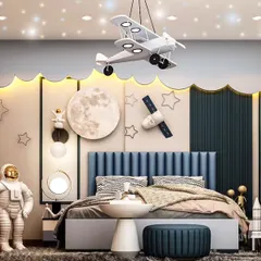 Another view of our popular space-themed kids' room. This angle highlights the custom bed with an astronaut figure, moon and satellite wall decor, and a ceiling light fixture designed to look like an airplane.