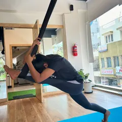 A beautiful suspended split pose, showcasing how the aerial hammock can help students achieve deeper stretches than on the mat.
