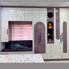 This multifunctional unit for a kids' room combines a wardrobe, drawers, display niches, and a window seat with storage underneath.