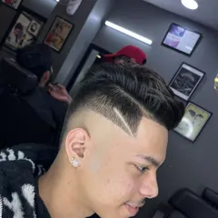 A classic side-part pompadour combined with a modern skin fade. The look is finished with a sharp, clean razor line for extra definition.