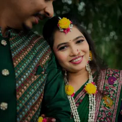 A close-up of the bride during her Haldi ceremony. Her joyful smile and the traditional yellow floral jewelry make for a beautiful and radiant portrait.