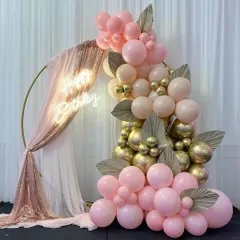 I love creating elegant and chic setups like this one. This beautiful photo corner features a gold ring draped with sequined and sheer fabric, a custom 'Happy Birthday' neon sign, and a stunning balloon cascade in pink, peach, and chrome gold.