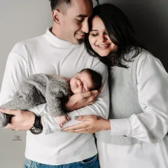 Another beautiful pose from the same session. The coordinated white and grey outfits create a clean and modern look for this new family of three.