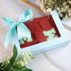The red travel combo, beautifully packaged in a window box with a blue ribbon, makes for a striking and practical gift.