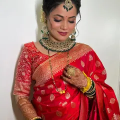A close-up of this stunning reception look. The focus is on flawless skin, expressive eyes, and a confident smile, ensuring the bride feels her absolute best.