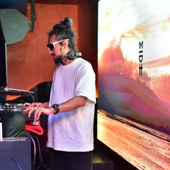 Another angle of me working the Pioneer DJ console, with the VJ screen displaying a vibrant, landscape-style visual that complements the music.