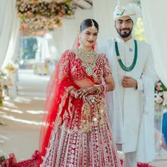 A beautiful moment between the bride and groom. Her makeup is designed to look flawless from every angle and in every light, ensuring she looks perfect in candid wedding photos.