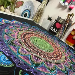 A close-up view of a finished mandala, showcasing the layers of color and intricate dot work. This is the kind of beautiful result you can achieve in one of my guided art sessions, even as a beginner.