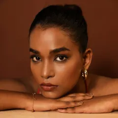 Flawless skin is an art. This close-up on a beautiful brown skin tone showcases a seamless, filter-free foundation blend that looks and feels like real skin.