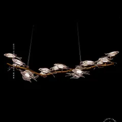 This horizontal chandelier features a flock of glass birds perched on a branch, as if in mid-flight. It's a perfect statement piece for suspension over a long dining table or in a living room, adding a dynamic and natural element.