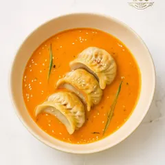 We elevate the humble momo into a gourmet dish. These delicate dumplings are served in a rich, aromatic broth and garnished with sesame seeds, creating a comforting yet sophisticated bowl of flavours.