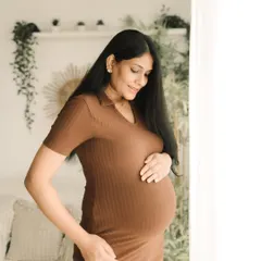 Looking radiant in a comfortable ribbed dress, this mom-to-be shows off her bump with a gentle smile. My studio sessions are designed to be relaxed and feel just like home.
