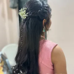 This half-up, half-down hairstyle features intricate braids and a delicate trail of pearls. It’s a beautiful way to add detail to your look while keeping your hair down.