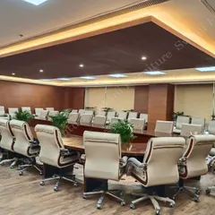 Another angle of the NBCC conference room, highlighting the arrangement of the executive chairs and the large, custom-built table designed for high-level meetings.