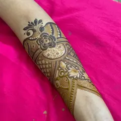 A full forearm piece with a central floral motif. The design uses a mix of bold and delicate patterns to create a balanced and beautiful look.