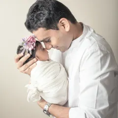 The connection between this father and his newborn is palpable. The way he looks at her speaks volumes, and it's my privilege to capture these powerful, unspoken emotions in a timeless photograph.
