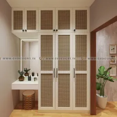This trendy wardrobe design features natural cane (rattan) panels set within a sleek, white Duco-painted frame. The attached dressing table with a backlit mirror makes it a complete and stylish solution for any bedroom.