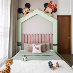 Designing for our youngest clients is always a joy. For this bedroom, we brought a touch of magic with a playful Mickey and Minnie Mouse mural peeking over a custom house-frame headboard, creating a fun and imaginative space for sleep and play.
