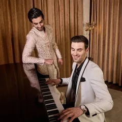 From tuxedos to Indo-Westerns, my atelier can cater to all your occasion wear needs. This shot captures a moment of celebration, highlighting two distinct but complementary styles for a modern Indian wedding.