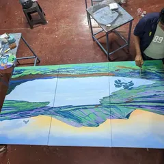 An overhead view of me working on the large canvases. This perspective shows the scale of the artwork and the focus required to paint the detailed reflections and foliage across the three panels.