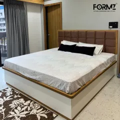 A clean and contemporary design featuring a brown tufted headboard set against a crisp white and wood-trimmed bed frame. This style is perfect for creating a serene and comfortable retreat with a touch of understated elegance.