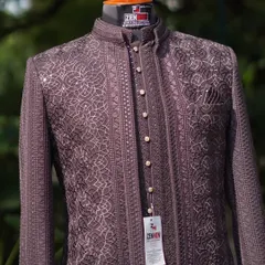 A close-up of the Jodhpuri suit, focusing on the button placket and the fine, geometric embroidery. The mother-of-pearl buttons add a touch of classic luxury.