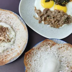 A perfect Sunday breakfast featuring our Pandi Curry. It's served here with soft appams, fried eggs, and sautéed oyster mushrooms for a complete and hearty Kodava-style meal.