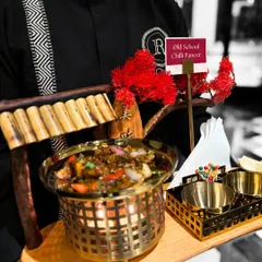 Our professional server presents the "Old School Chilli Paneer" on a custom tray. This shows our commitment to providing a complete service experience, where even the appetizers are served with flair.