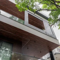 This shot captures the striking geometry of the facade, where wood-clad sections frame the balconies. We also integrated a perforated metal screen, adding a layer of texture and privacy to the upper level.