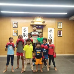 This is my kids' MMA group at The Dojo, all gloved up and ready to learn. We start with the basics of boxing, teaching them how to stand and hold their hands correctly.