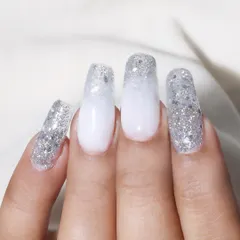 A beautiful example of glitter ombre nails. This design features a soft white base that fades into a dense silver glitter tip, perfect for a winter or bridal theme.