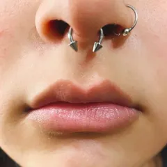 A close-up of a well-placed septum piercing, also known as a bull ring. I check your anatomy carefully to ensure the piercing is centered and sits correctly for maximum comfort.