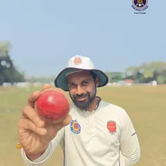 Our player and coach, Shreenesh Shah, holding the ball after his historic 10-wicket haul in a Kanga League match. He demonstrates the skill and dedication we instill in our players.
