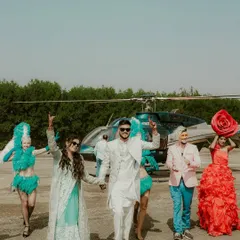 A grand entrance that sets the tone for an epic celebration. The couple arrives by helicopter, greeted by performers, a moment of pure spectacle that I capture to tell the story of a truly unique wedding.