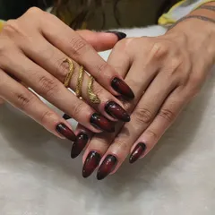 Elegance with an edge. This stunning set features a deep burgundy and black ombré effect on long, almond-shaped nails for a look that is dark, mysterious, and incredibly chic.