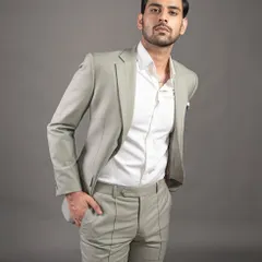 A modern take on the business suit in a light sage green. Paired with a crisp white shirt, this two-piece suit offers a fresh yet professional look.