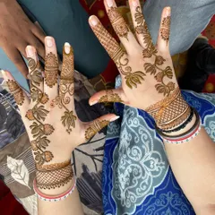 This Arabic-inspired design features beautiful floral vines that flow gracefully across the hands. The style is elegant and leaves more skin showing, which many clients love.
