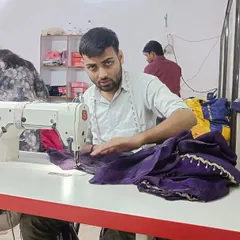 Meet one of my skilled artisans, hard at work on his sewing machine. The dedication of my team ensures that every garment meets the highest standards of quality.
