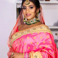For this reception look, we chose a classic pink saree with green jewelry. The makeup was kept elegant and defined to match the timeless feel of her outfit.