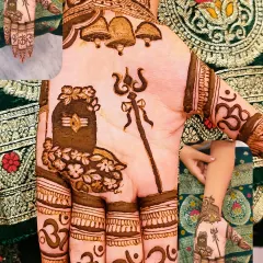 A powerful Sawan special mehandi featuring a Shivling, Trishul, and temple bells. The fingers are decorated with the 'Om' symbol, completing the divine theme.