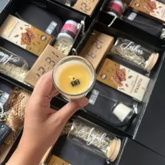 For a corporate client's 10th anniversary, I created these special hampers featuring a candle with a hidden message that reveals itself as it burns. It's these little details that turn a corporate gift into a memorable experience.