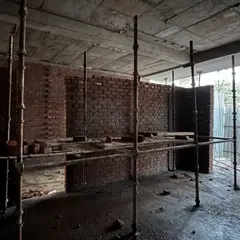 An interior view during the construction phase, with scaffolding in place. This raw view shows the bare shell before we begin the intricate work of layering materials, textures, and finishes.