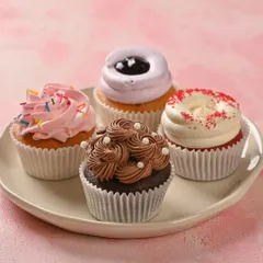 We love getting creative with our cupcakes. This plate features some of our favorites: a classic chocolate, a fun sprinkle cupcake, a tangy blueberry, and a rich red velvet. Each one is a little bite of happiness.