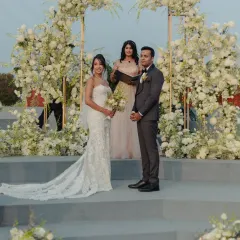 This modern Christian wedding ceremony featured a stunning asymmetrical floral arch, creating a chic and elegant backdrop for the couple to exchange their vows.