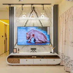 The TV unit is often the focal point of a living room. For this wall, I used a combination of white marble finish, fluted panels, and track lighting to create a modern and luxurious backdrop for the entertainment center.